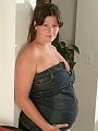Brunette pregnant babe is stripping and posing